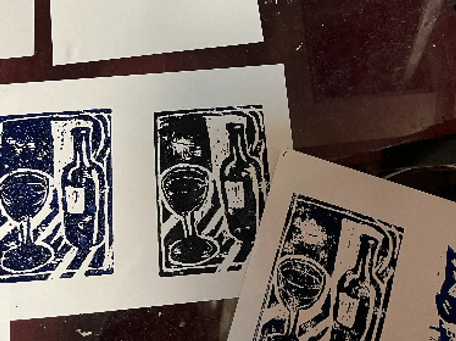 Prints of wine bottle and glass on paper.