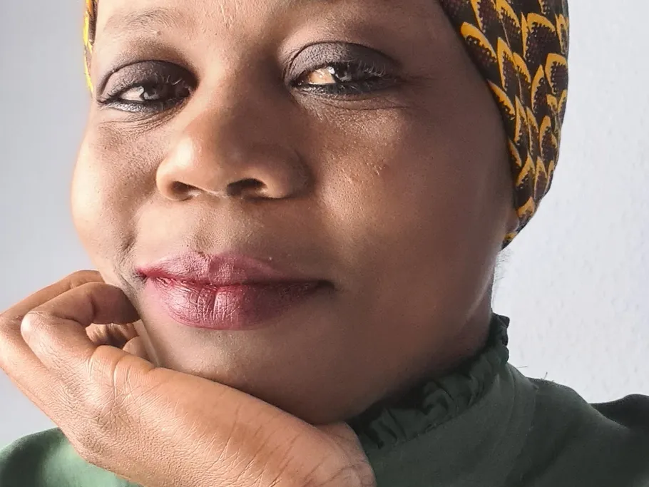 Person in green top with hand on chin.