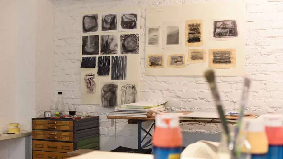 Kunststudio mit abstrakten Gemälden an weißer Wand.