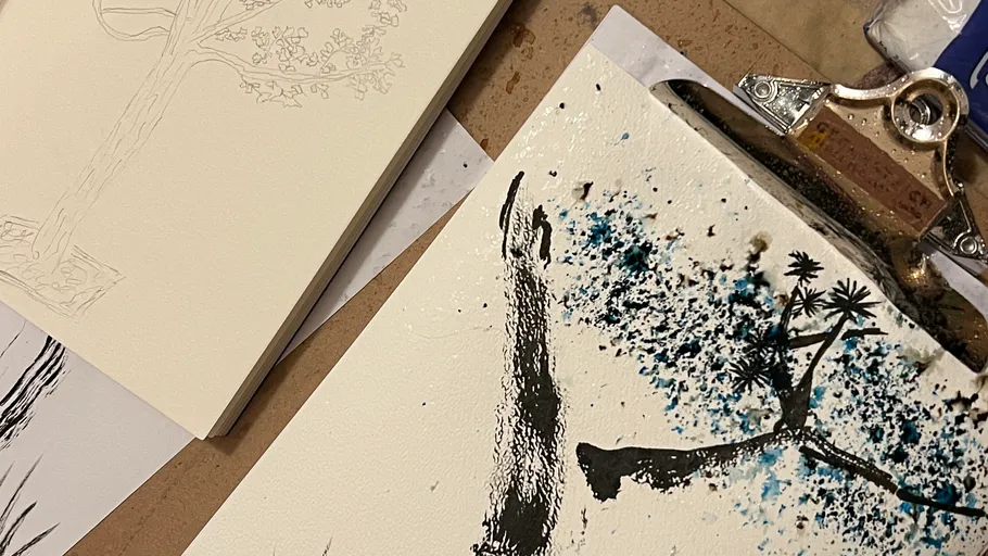 Art supplies on table, drawing in progress.