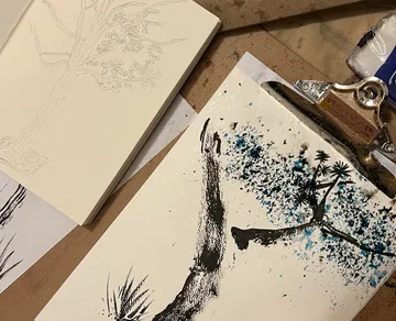 Artistic tree drawing on paper with clipboard.