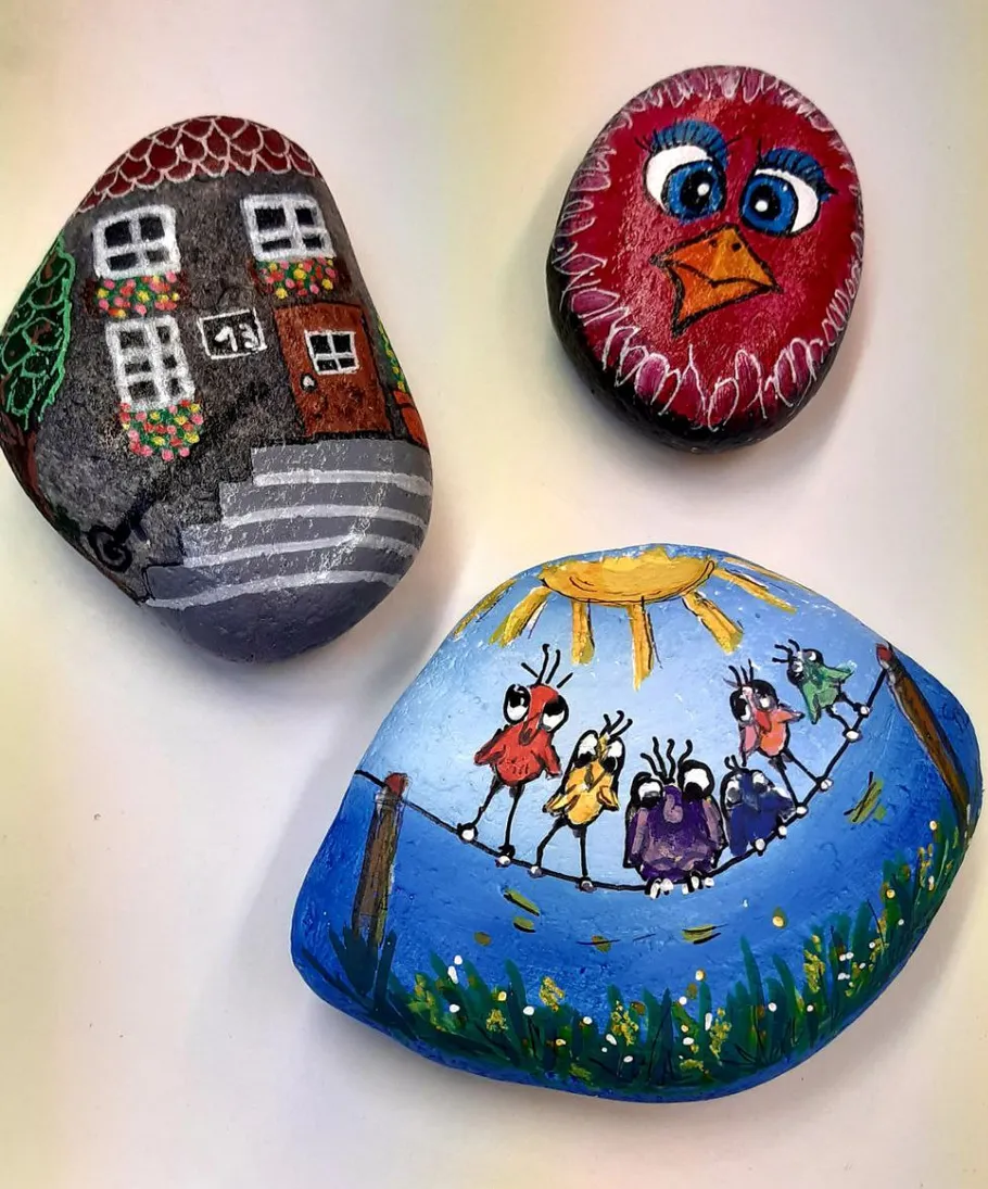 Painted rocks with colorful designs displayed.