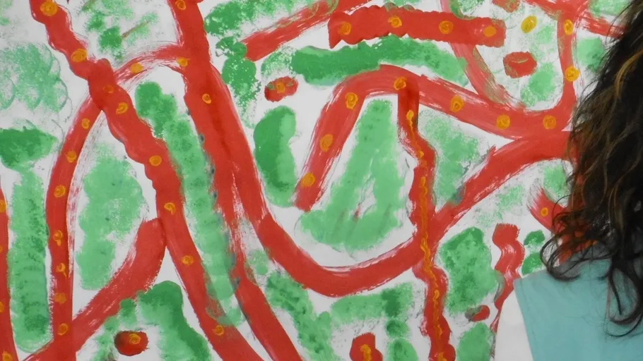 Abstract red and green painting with person partially visible.