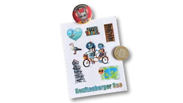 Sheet with stickers and a magnet on left.
