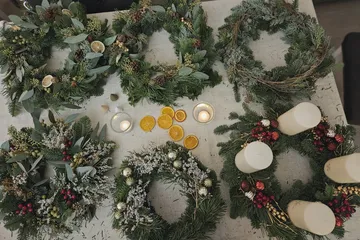 Christmas wreaths arranged on a table.