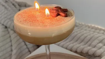 Candle in cocktail glass, gingerbread topper.
