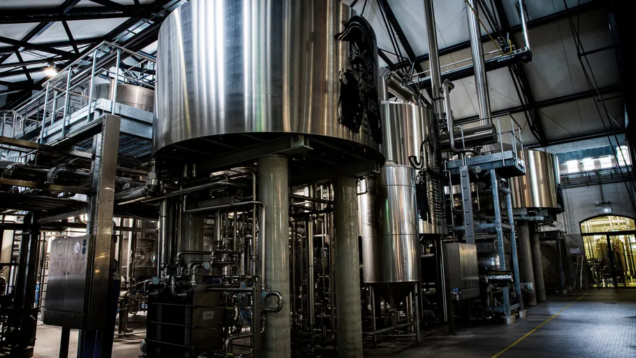 Large metal tanks in a brewery setting.