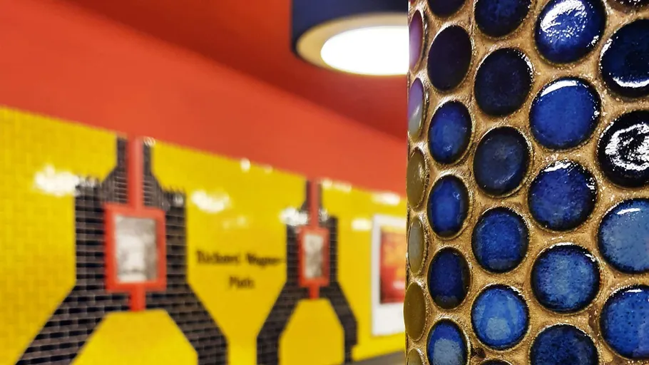 Colorful mosaic column in subway station.