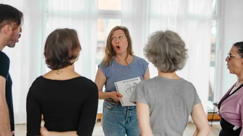 Group of people in discussion indoors.