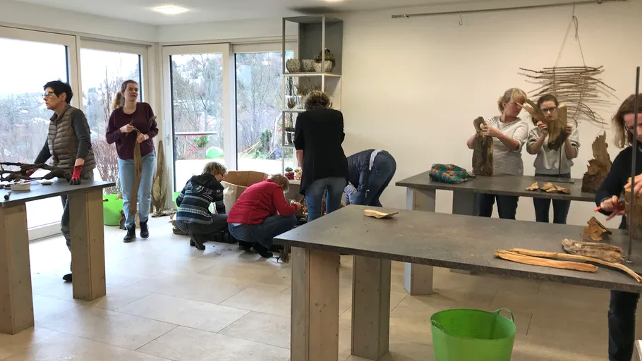 People crafting in a bright indoor room.