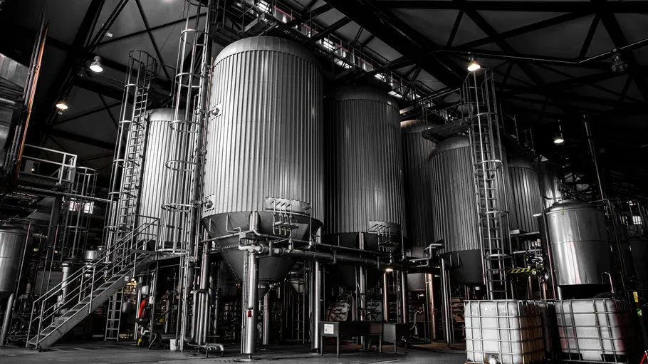 Large metal silos in industrial factory.