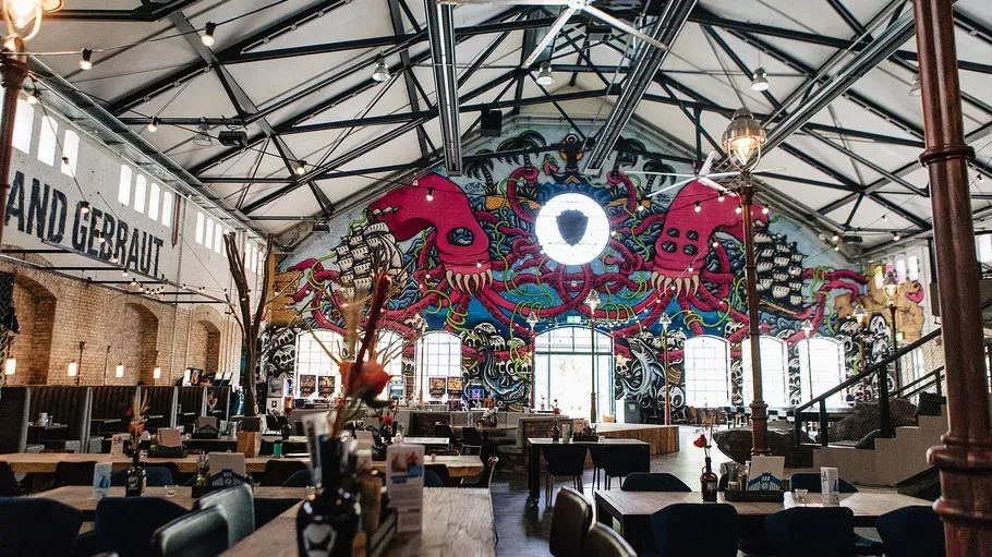 Colorful mural in spacious restaurant interior.