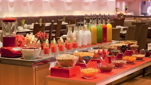 Buffet with fruits, cereals, and juice in restaurant.