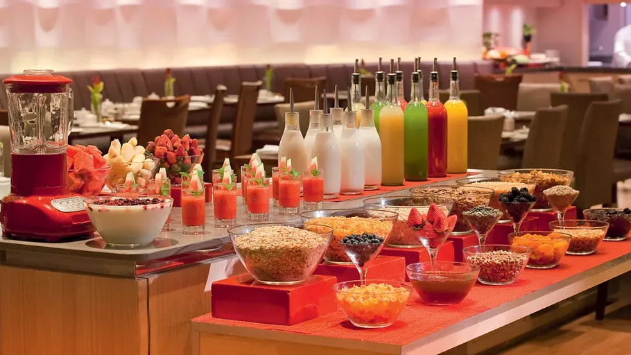 Buffet with fruits, cereals, and juice in restaurant.