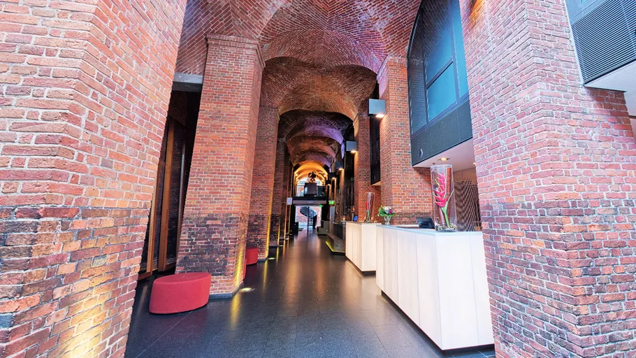 Brick hallway with modern reception desk.