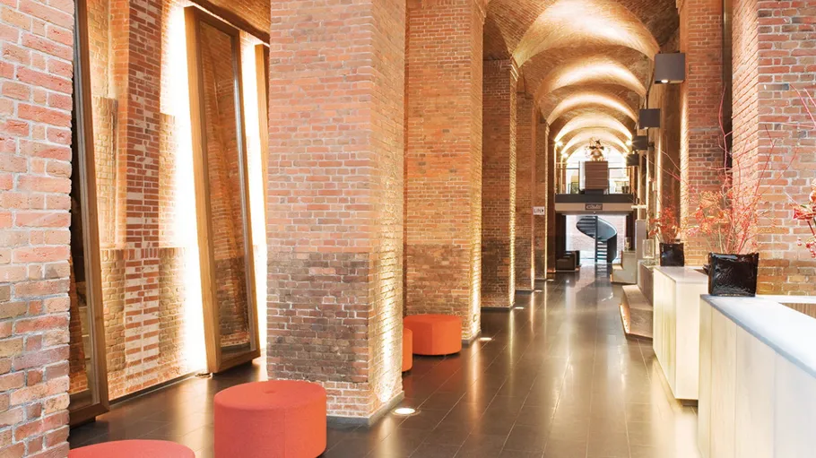 Brick hallway with modern lighting fixtures.