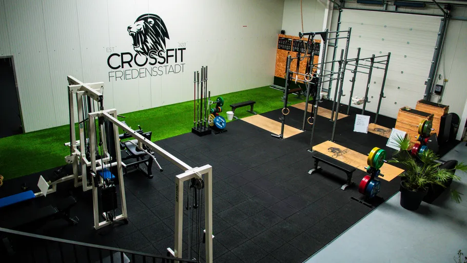 Gym with equipment and CrossFit logo.
