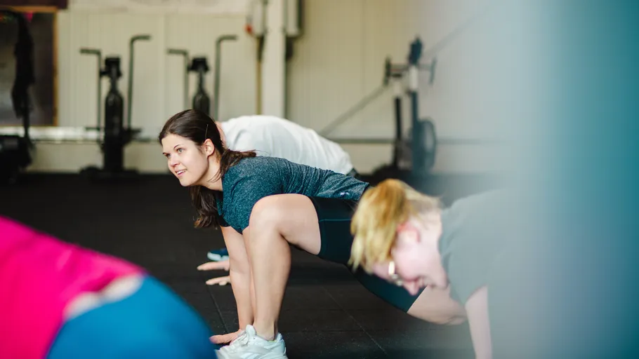 People stretching in a gym environment.