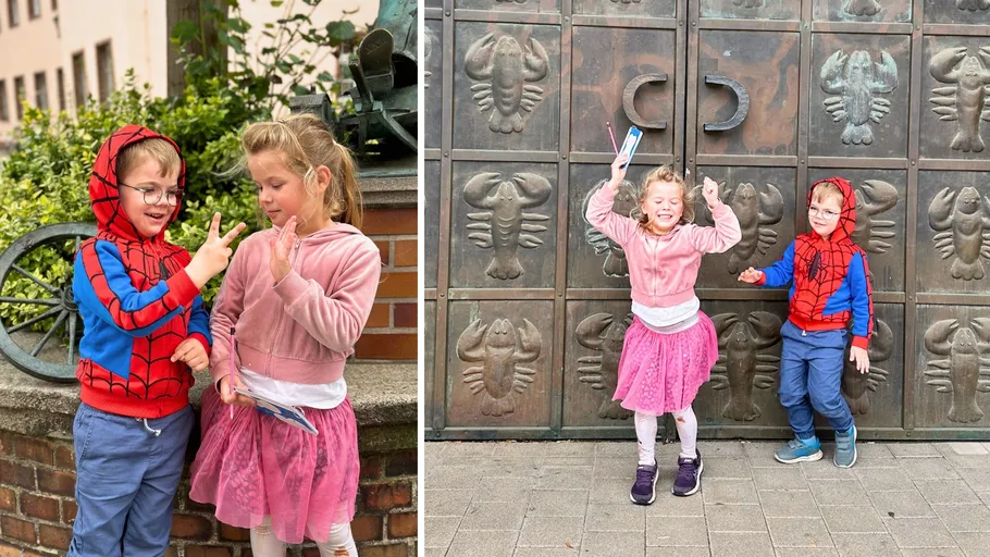 Two children in costumes playing outdoors.