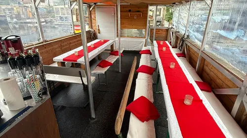 Outdoor seating area with red tablecloths.