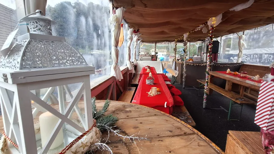 Festive outdoor seating with decorations and lanterns.