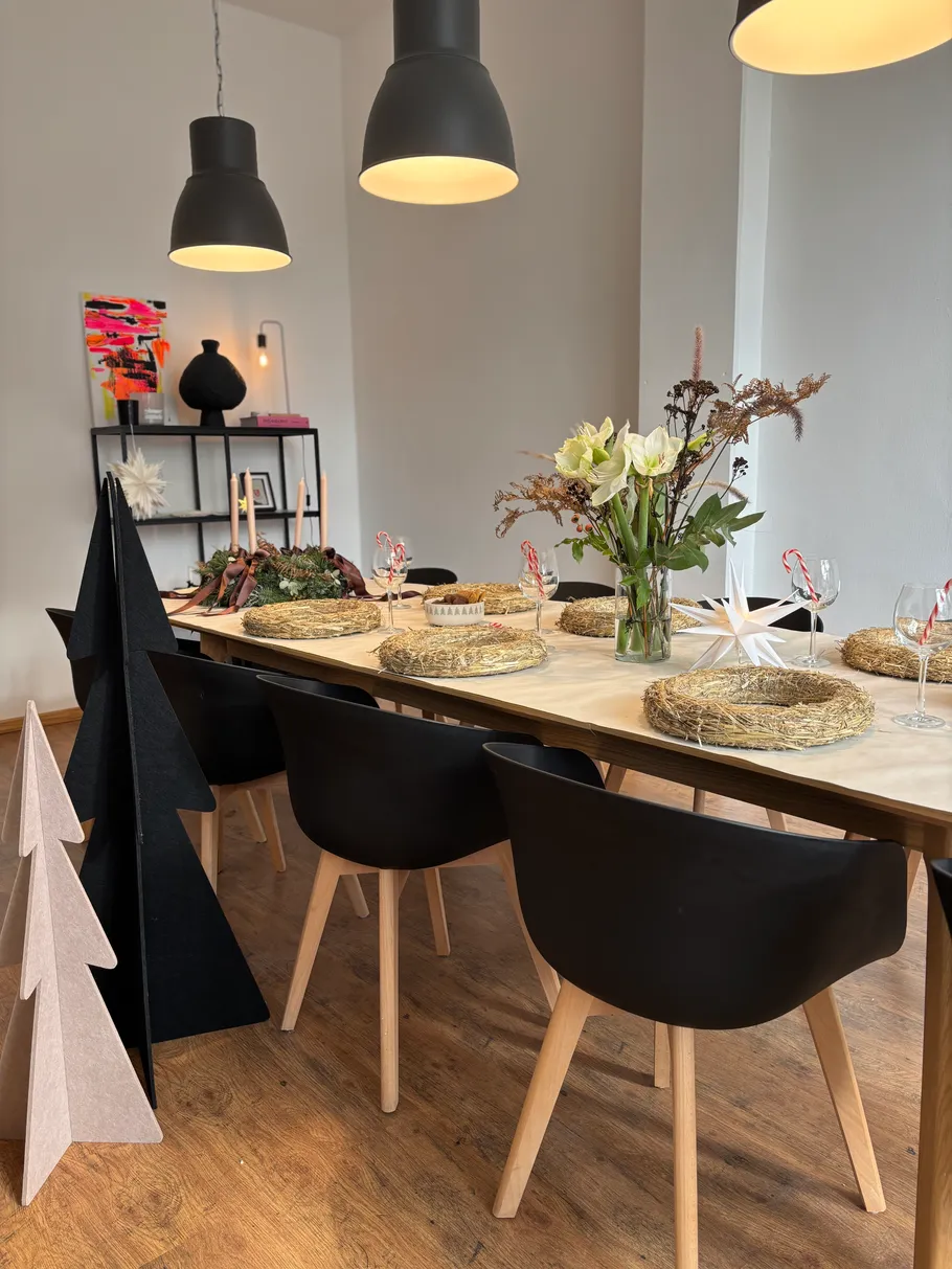 Dining table set with flowers and decorations.