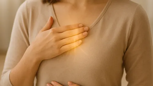 Person touching chest with glowing light effect.
