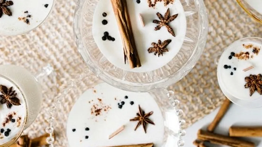 Cinnamon spice drinks on a woven mat.