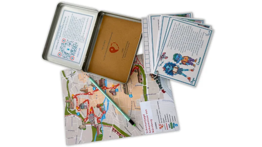 Tin box with map, pencil, cards scattered.