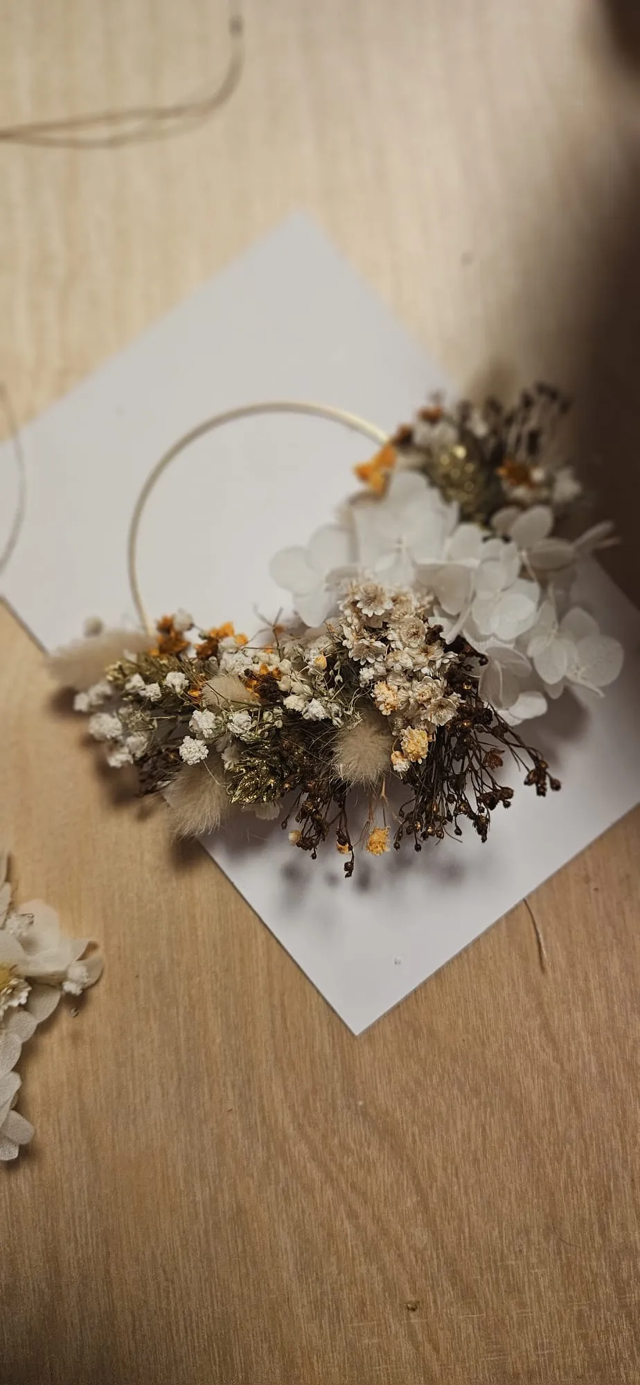 Floral wreath on wooden table surface.