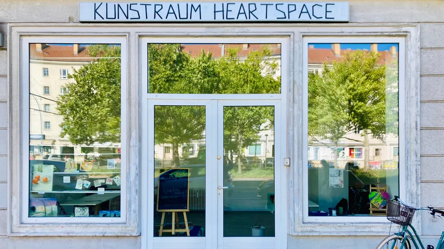 Art gallery storefront with large glass windows.