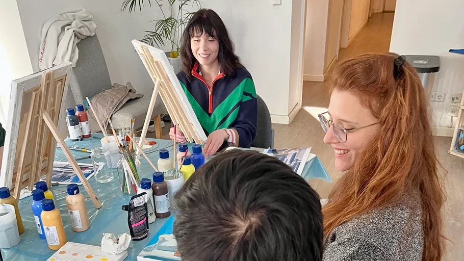 Group painting together at a table.