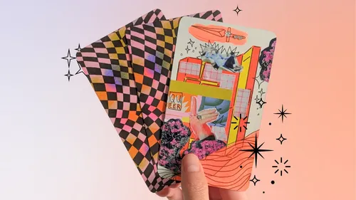 Three colorful tarot cards held in hand.