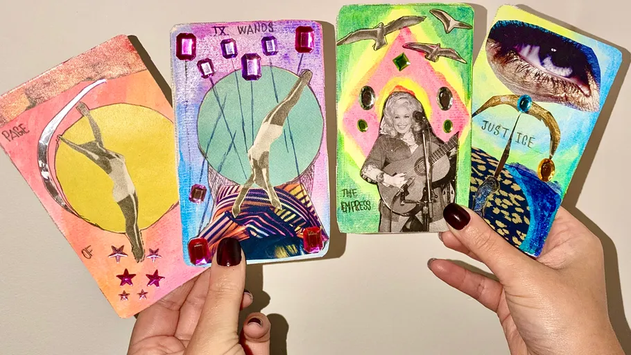 Colorful tarot cards held in hands.