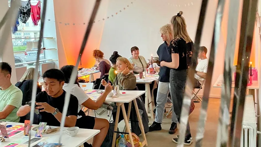 People painting and talking in art class.