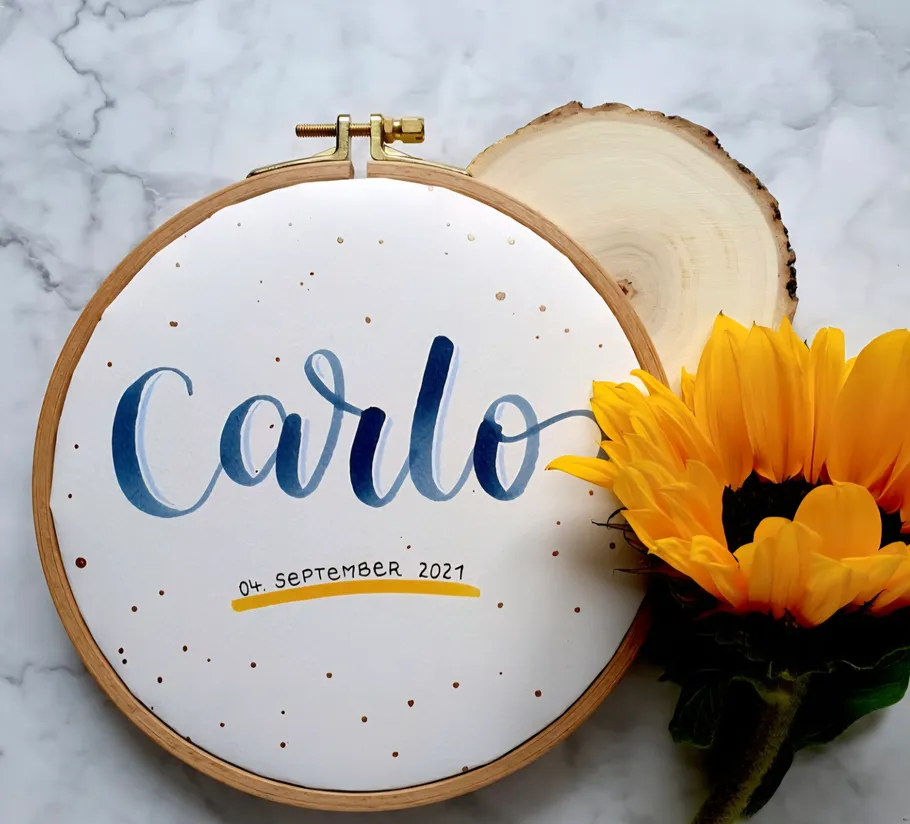 Embroidery hoop with name and sunflower.