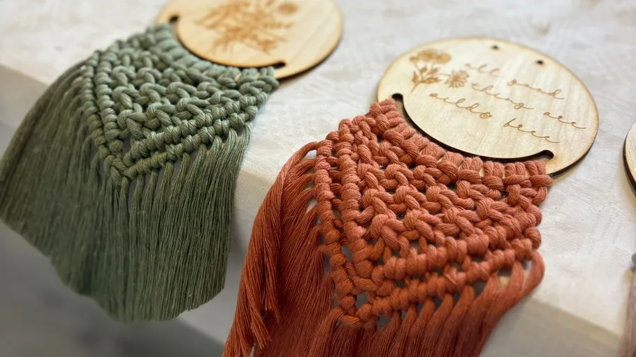 Macramé hangings with engraved wood tops.