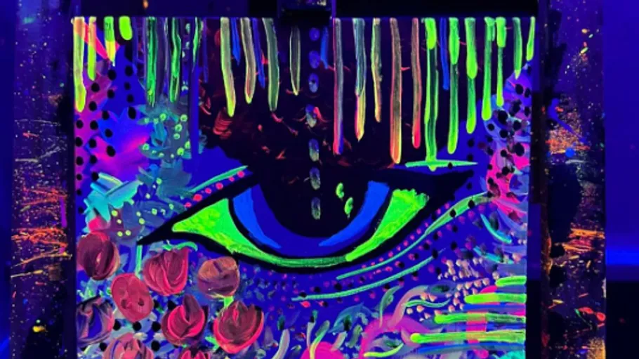 Neon abstract art with eye in dark room.