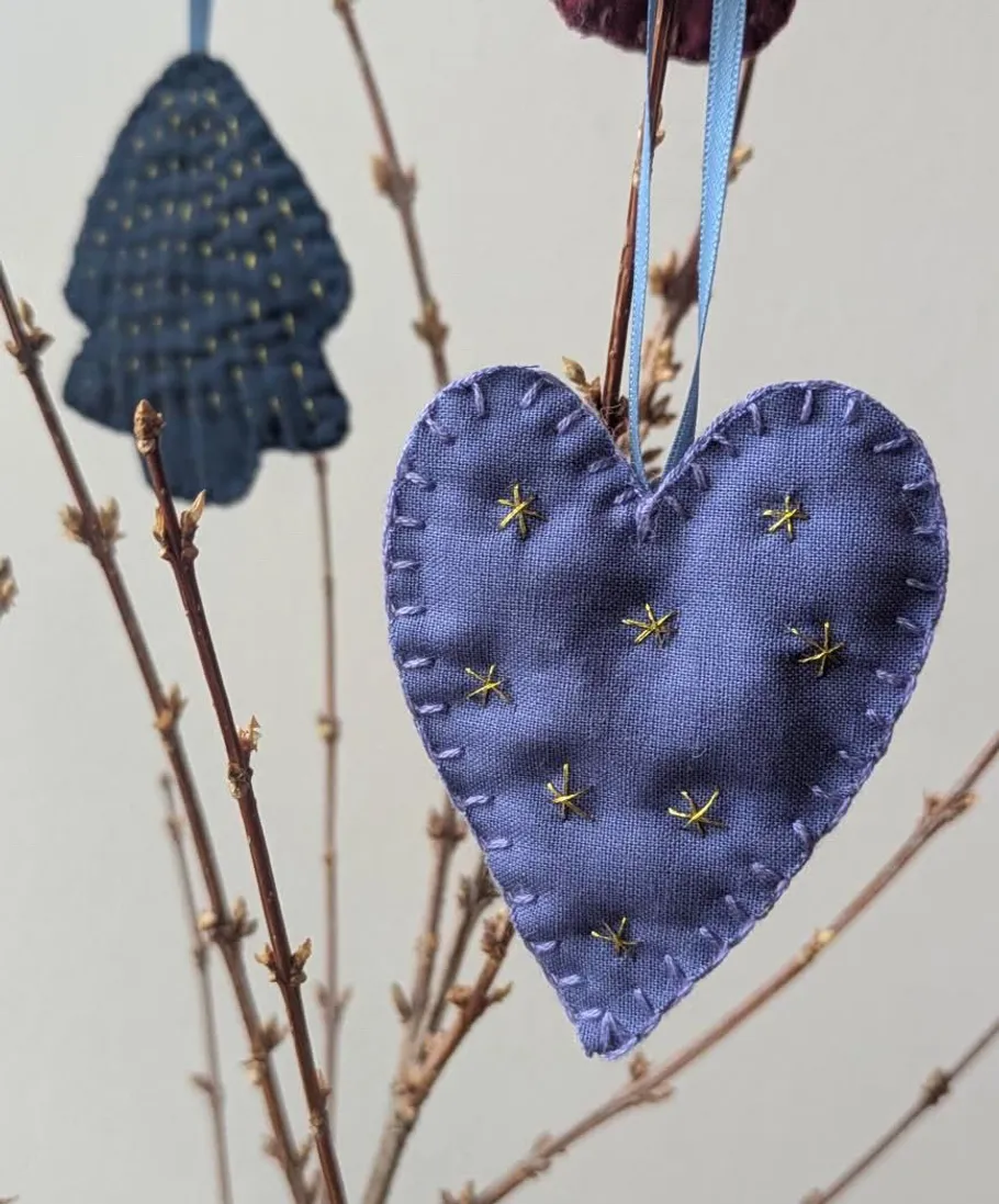 Heart-shaped ornament hanging on a branch.