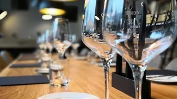Empty wine glasses on a wooden table.
