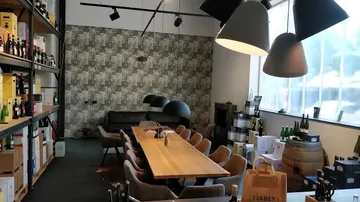 Meeting room with wooden table and wine decor.