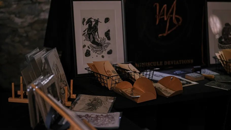 Art prints and items displayed on table.