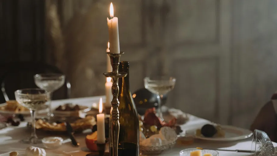 Candles on table with dinner setting.