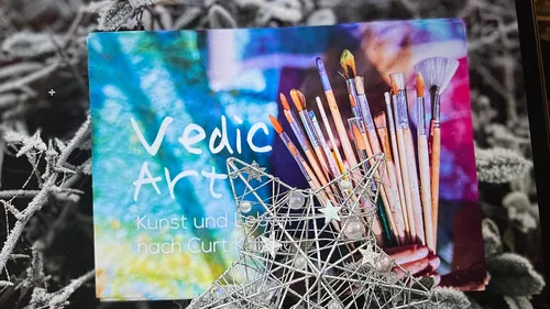 Painting brushes behind wire star on frosted surface.