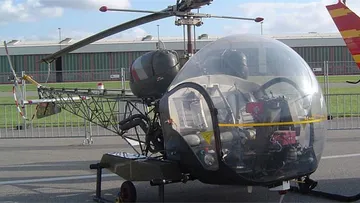 Historic helicopter displayed at airfield.