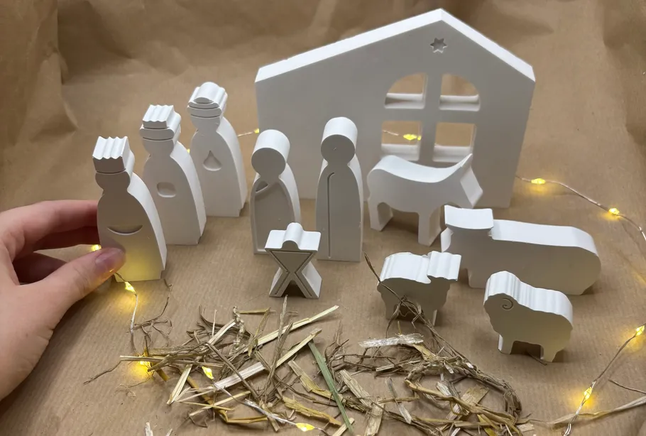 Minimalistische Krippe mit Hand und Lichtern.