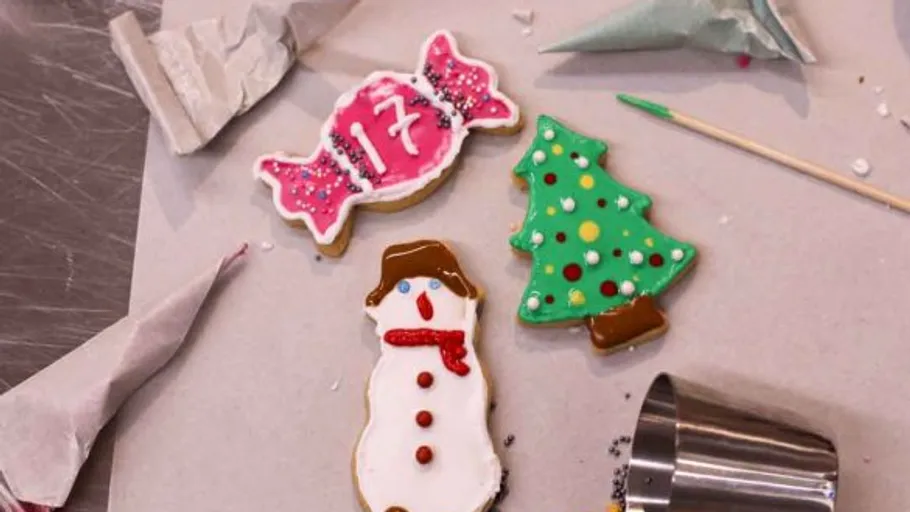Decorated cookies shaped like candy, tree, snowman.