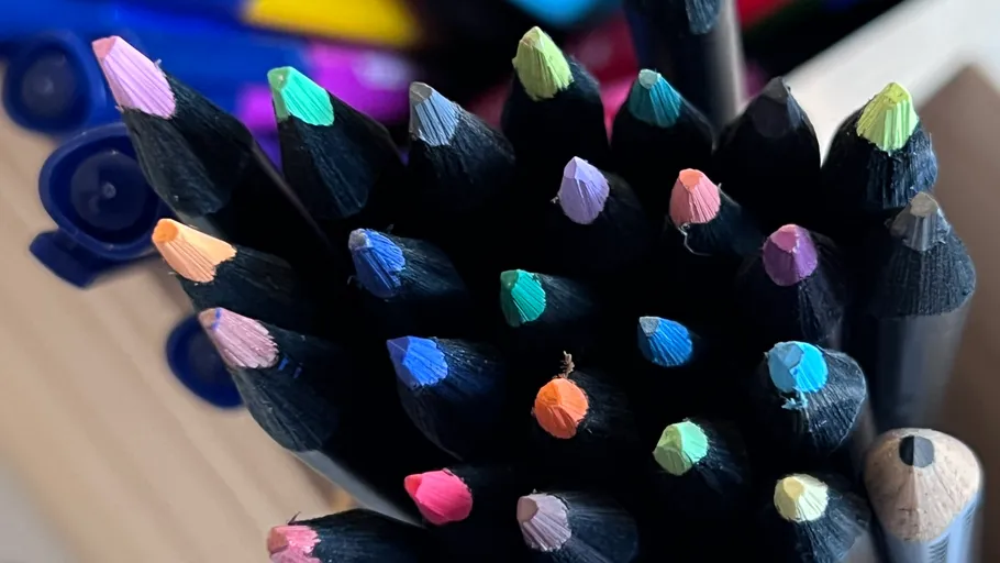 Colored pencils in a cup, viewed from above.