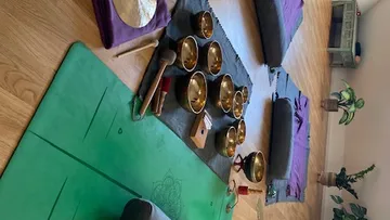 Tibetan singing bowls on mats in a studio.