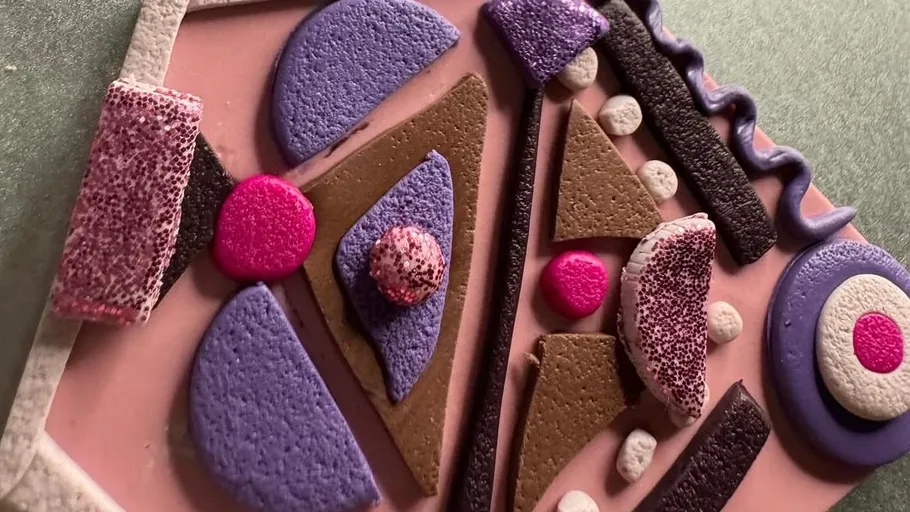 Abstract art piece with geometric shapes, textured surface.